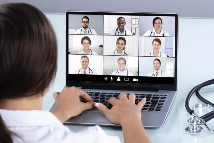 Doctor Video Conferencing With Female Colleague On Laptop